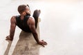 Calm muscular athlete with beard finishing exercise