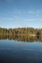 Calm Northern Ontario lake in early morning with reflected cloud Royalty Free Stock Photo