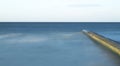 Calm Ocean with Breakwater Structure Royalty Free Stock Photo