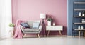 The Calm Palette of a Grey Armchair Blending with a Pink Wall in a Roomy Bedroom Royalty Free Stock Photo