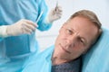 Calm patient waiting for medical specialist stitch up his face Royalty Free Stock Photo