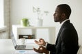 Calm peaceful african-american businessman in suit meditating at Royalty Free Stock Photo