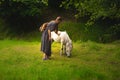 Calm peaceful fairy tale photography tender woman with pony in green grass meadow on forest edge in spring clear weather day