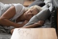 Calm peaceful healthy elderly woman enjoying sleeping recovery