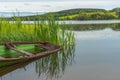 A calm peaceful lake with fishing boat and reflections.