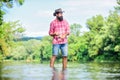 Calm and peaceful mood. Fisherman alone stand in river water. Man bearded fisherman. Fisherman fishing equipment. Some Royalty Free Stock Photo