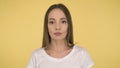 Calm peaceful woman on yellow background in studio isolated. Middleweight woman in basic white t-shirt