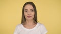 Calm peaceful woman on yellow background in studio isolated. Middleweight woman in basic white t-shirt