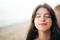 Calm portrait of happy fashionable boho woman relaxing at sandy cliff on tropical island. Stylish hipster girl walking on beach at Royalty Free Stock Photo