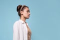 calm portrait in profile, a young beautiful woman in a white shirt,