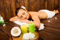 Calm pretty young woman laying in spa salon with closed eyes and relaxed Royalty Free Stock Photo