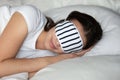 Calm relaxed millennial woman sleeping in bed wearing stylish eyemask Royalty Free Stock Photo