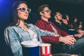 Calm and relaxed students are watching movie. They are sitting together in one row. People are very happy. Royalty Free Stock Photo