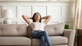 Calm relaxed young asian ethnic woman sleeping on cozy couch. Royalty Free Stock Photo