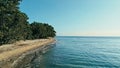 Calm and relaxing aerial drone image of a stunning beautiful hidden remote ocean sea shore at sunset with an endless sandy beach Royalty Free Stock Photo