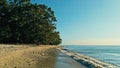 Calm and relaxing aerial drone image of a stunning beautiful hidden remote ocean sea shore at sunset with an endless sandy beach Royalty Free Stock Photo