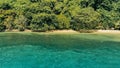 Calm and relaxing aerial drone image of a stunning beautiful hidden remote ocean sea shore at sunset with an endless sandy beach