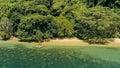 Calm and relaxing aerial drone image of a stunning beautiful hidden remote ocean sea shore at sunset with an endless sandy beach Royalty Free Stock Photo