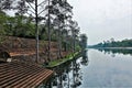 Calm river in ancient Angkor. Stone steps descend from the ruins of a brick wall to the water.