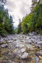 A calm river flowing through a stony trough. Royalty Free Stock Photo