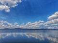 Calm Riverside Nature and Bright Blue Sky With Clouds