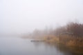 Calm scene at a lonely lake in fog