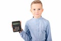 Calm Schoolboy holding calculator. Portrait of funny cute 10s boy .White background Royalty Free Stock Photo