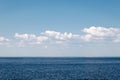Calm sea on a background of blue sky with cloudsCalm sea against blue sky with clouds. Harmony of sea elements. Seascape. Copy Royalty Free Stock Photo