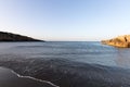 Calm sea beach and rocks a woman alone in the distance