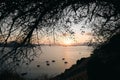 Calm sea with boats sailing over a background of a beautiful sunset Royalty Free Stock Photo