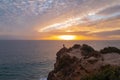 Calm sea and rock with sunset sky and sun through the clouds over. Ocean and sky background, seascape, ibiza. Royalty Free Stock Photo