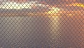 Calm sea and sunset behind a fence made of Rabitz netting.Closed territory or private water area with limited access. Illustration