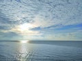 Calm sea with sunset sky and sun through the clouds over. Tranquil seascape. Horizon over the water. Royalty Free Stock Photo