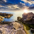 Calm sea wave touches boulders at sunset Royalty Free Stock Photo