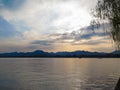 A calm seascape with mountains at sunset. Dramatic sky and cloudscape Royalty Free Stock Photo