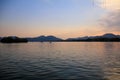 A calm seascape with mountains at sunset. Dramatic sky and cloudscape Royalty Free Stock Photo