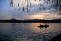 A calm seascape with mountains at sunset. Dramatic sky and cloudscape Royalty Free Stock Photo