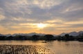 A calm seascape with mountains at sunset. Dramatic sky and cloudscape Royalty Free Stock Photo