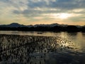 A calm seascape with mountains at sunset. Dramatic sky and cloudscape Royalty Free Stock Photo