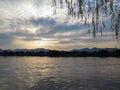 A calm seascape with mountains at sunset. Dramatic sky and cloudscape Royalty Free Stock Photo