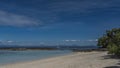 A calm seascape. A sandy beach and rocks exposed at low tide. Royalty Free Stock Photo