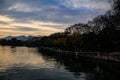 A calm seascape with trees and mountains at sunset. Dramatic sky. Royalty Free Stock Photo