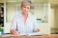 Calm senior lady working at reception