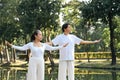 Calm senior people practicing posture during Tai Chi class, finding balance and calmness in nature