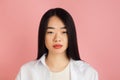 Asian young woman's portrait on pink studio background. Concept of human emotions, facial expression, youth, sales, ad. Royalty Free Stock Photo