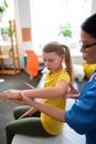 Calm skinny long-haired child pulling hands and presenting abilities