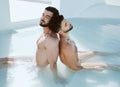 Calm, sleep and men in a pool for swimming, relaxation and summer enjoyment. Spa, hot tub and or an lgbt gay couple Royalty Free Stock Photo