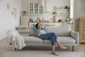 Calm sleepy middle aged woman resting on soft couch