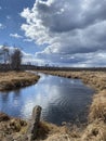 A calm spring forest river on a sunny and cloudy day Royalty Free Stock Photo