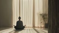 A calm and still person meditating in a minimalist interior